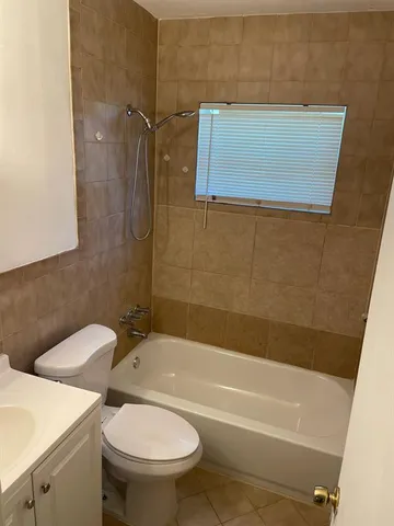 a bathroom with a toilet and a bathtub