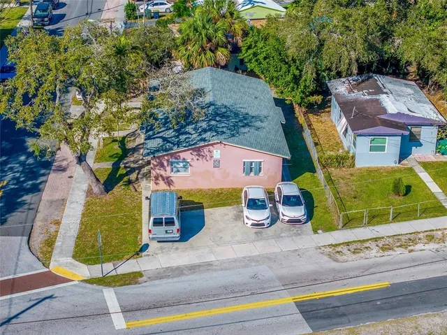 an aerial view of a house with garden space and sitting space