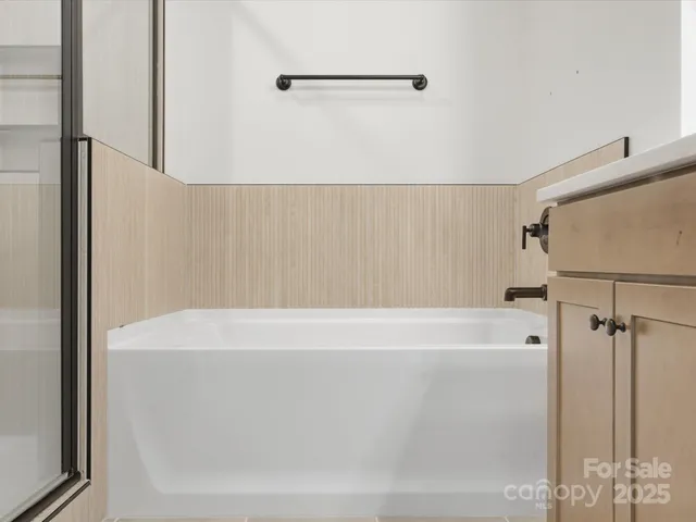 a white bath tub sitting next to a white sink