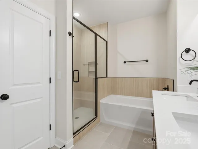 a bathroom with a bathtub a toilet and a shower