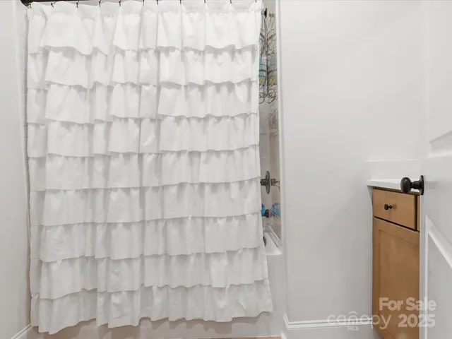 a bathroom with a shower curtain and a sink