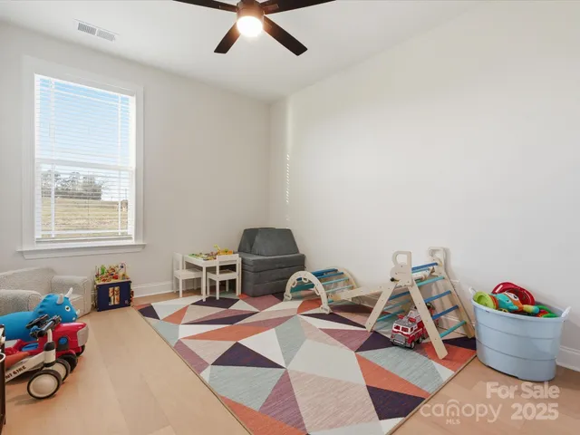 a room with furniture a rug and a window