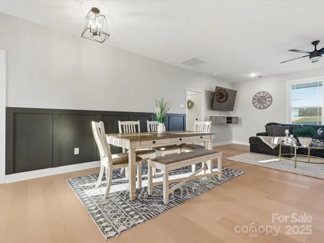 a living room with furniture a rug and a window