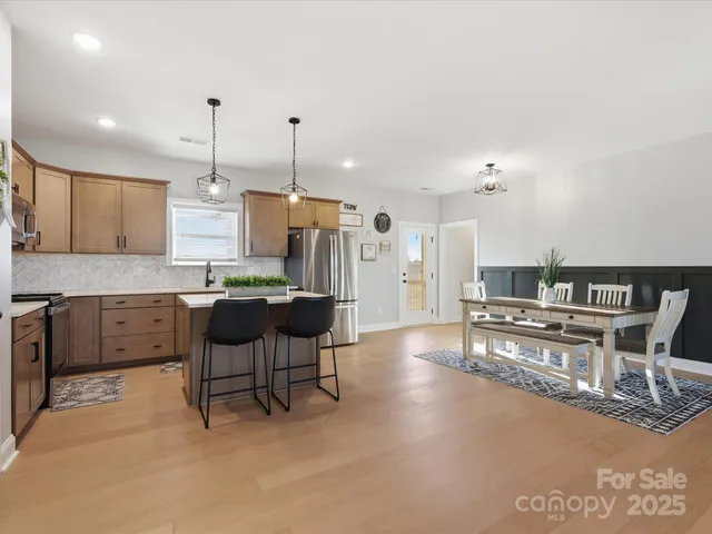 a large kitchen with a table and chairs