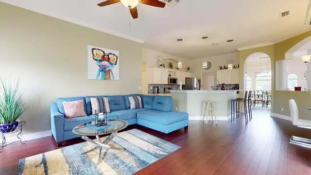 a living room with furniture and wooden floor