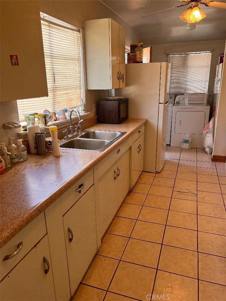 15119 Studebaker Road Norwalk, CA 90650 - Photo 2 of 3 a kitchen with stainless steel appliances a sink window and cabinets