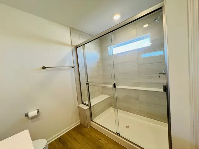 a bathroom with a glass shower door