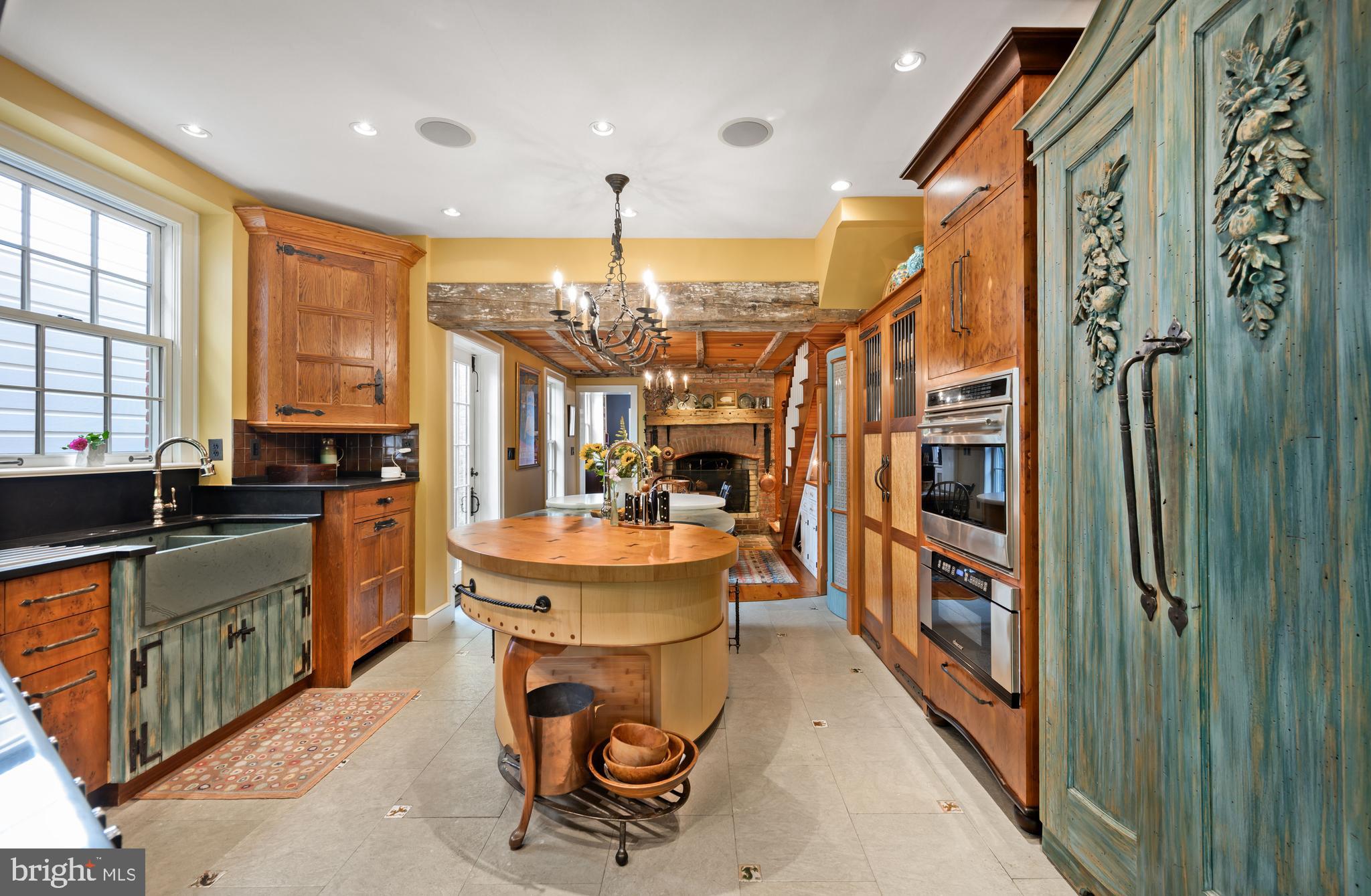511 Queen Street Alexandria, VA 22314 - Photo 23 of 58 a kitchen with stainless steel appliances kitchen island granite countertop a refrigerator a stove and a sink with wooden floor