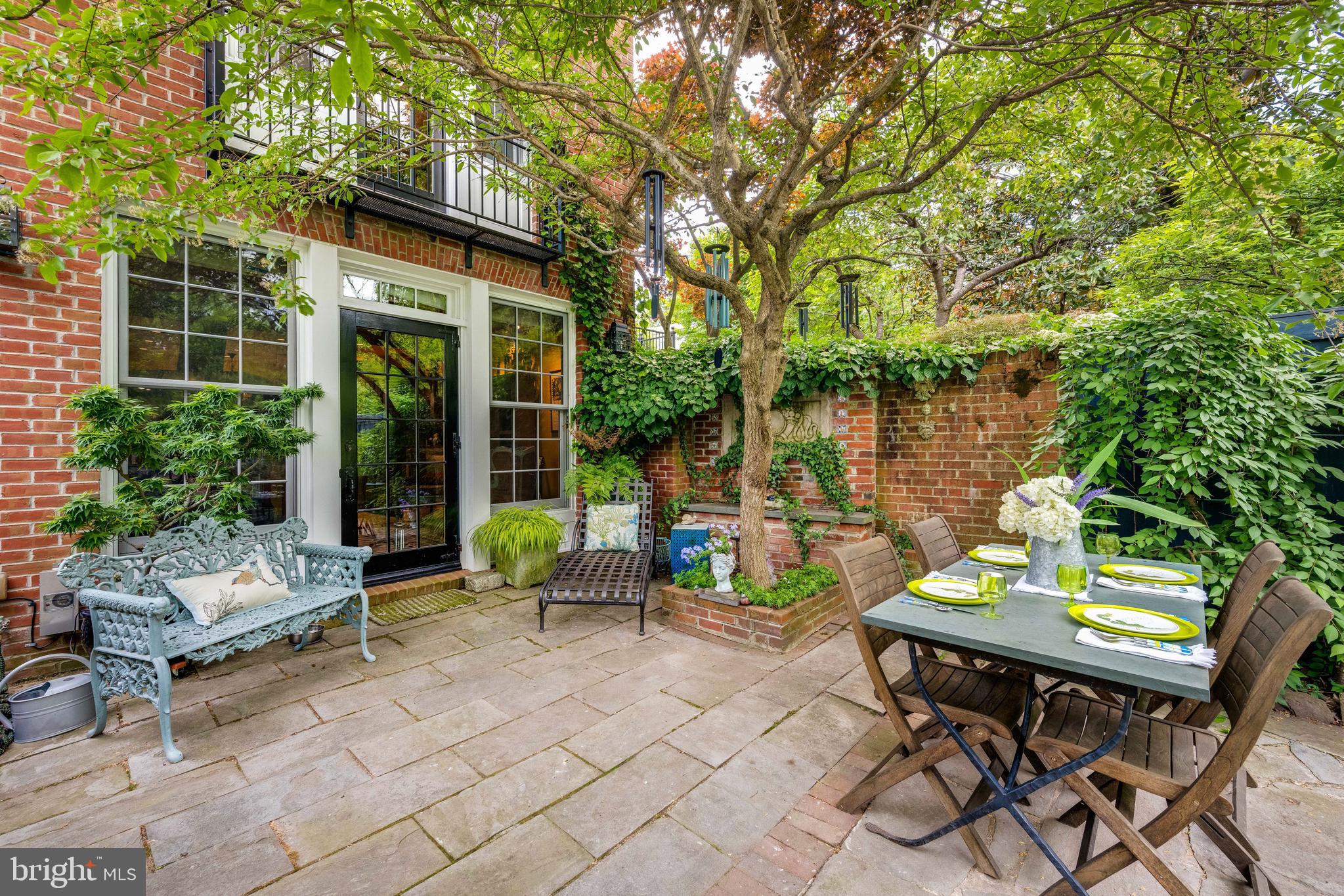 511 Queen Street Alexandria, VA 22314 - Photo 52 of 58 a view of a patio with table and chairs and potted plants