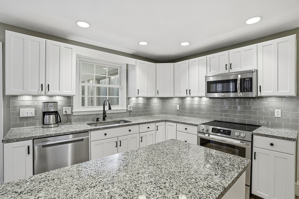 6 Hickory Lane Upton, MA 01568 - Photo 16 of 36 a kitchen with stainless steel appliances granite countertop a sink stove and microwave