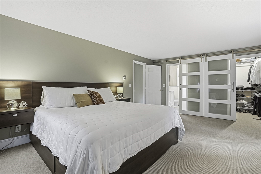 6 Hickory Lane Upton, MA 01568 - Photo 28 of 36 a large bed sitting in a bedroom next to a large window