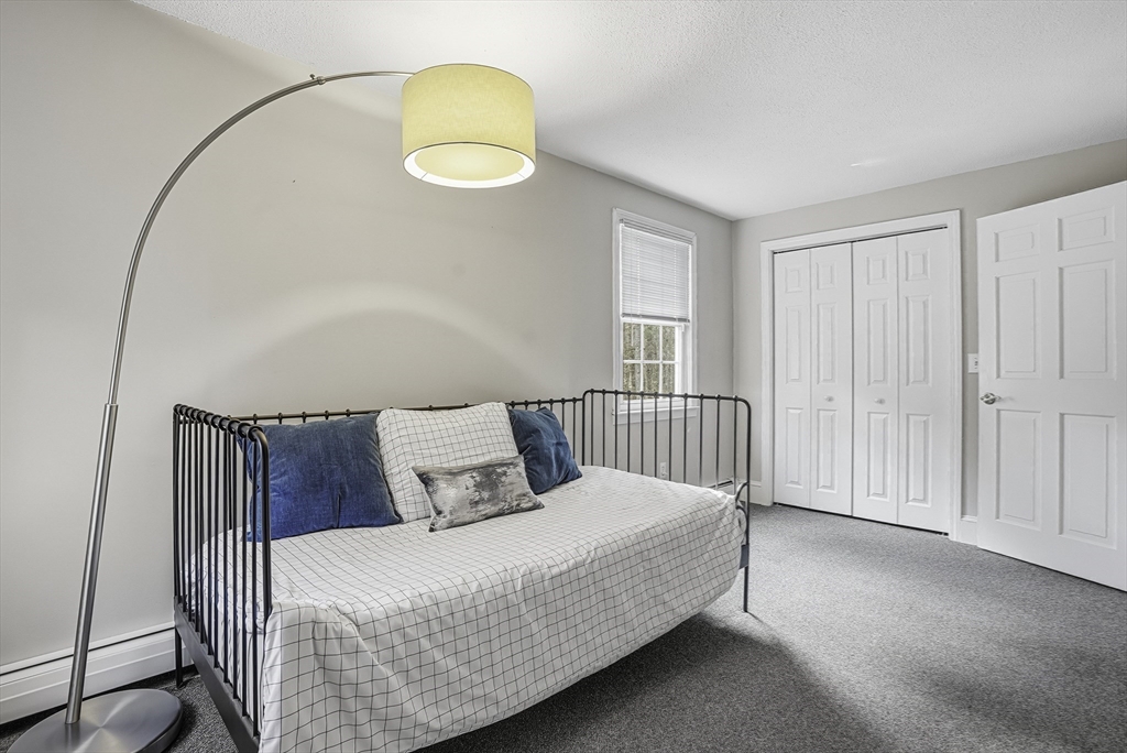 6 Hickory Lane Upton, MA 01568 - Photo 32 of 36 a bed sitting in a bedroom next to a window