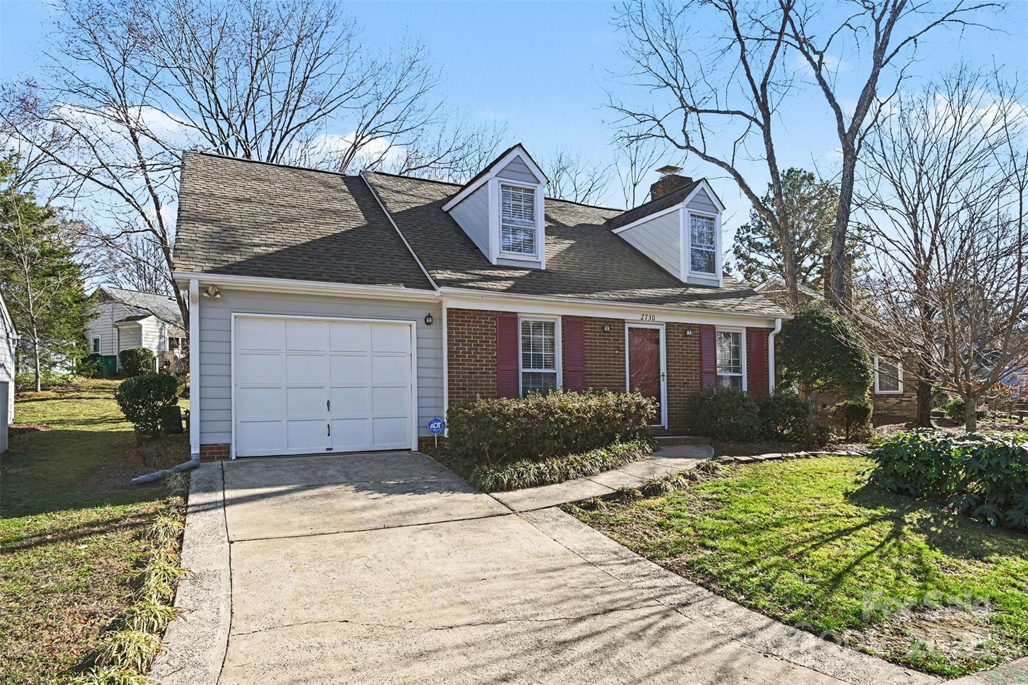 2730 Quailrush Road Charlotte, NC 28226 - Photo 2 of 22 a front view of a house with a yard and garage