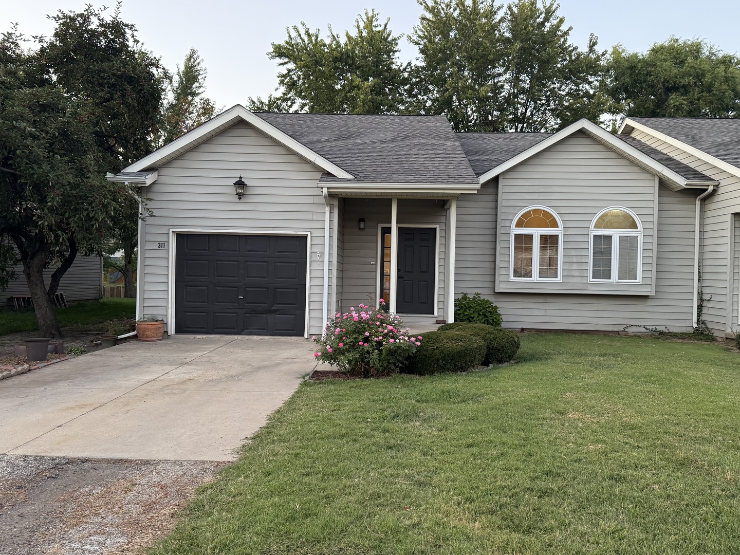 a front view of a house with a garden