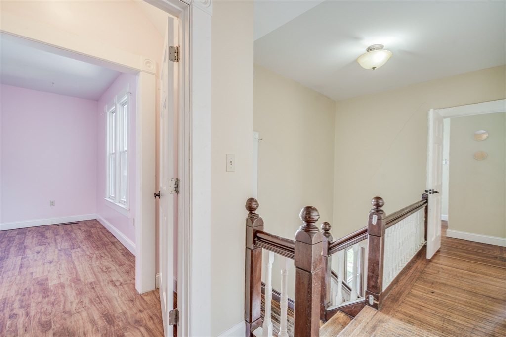 92 Mill Street Springfield, MA 01108 - Photo 14 of 35 a view of a hallway with wooden floor and stairs