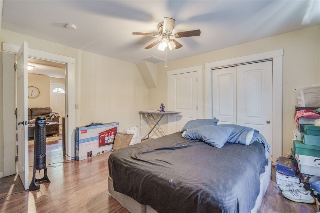 92 Mill Street Springfield, MA 01108 - Photo 26 of 35 a bedroom with a bed and a chandelier