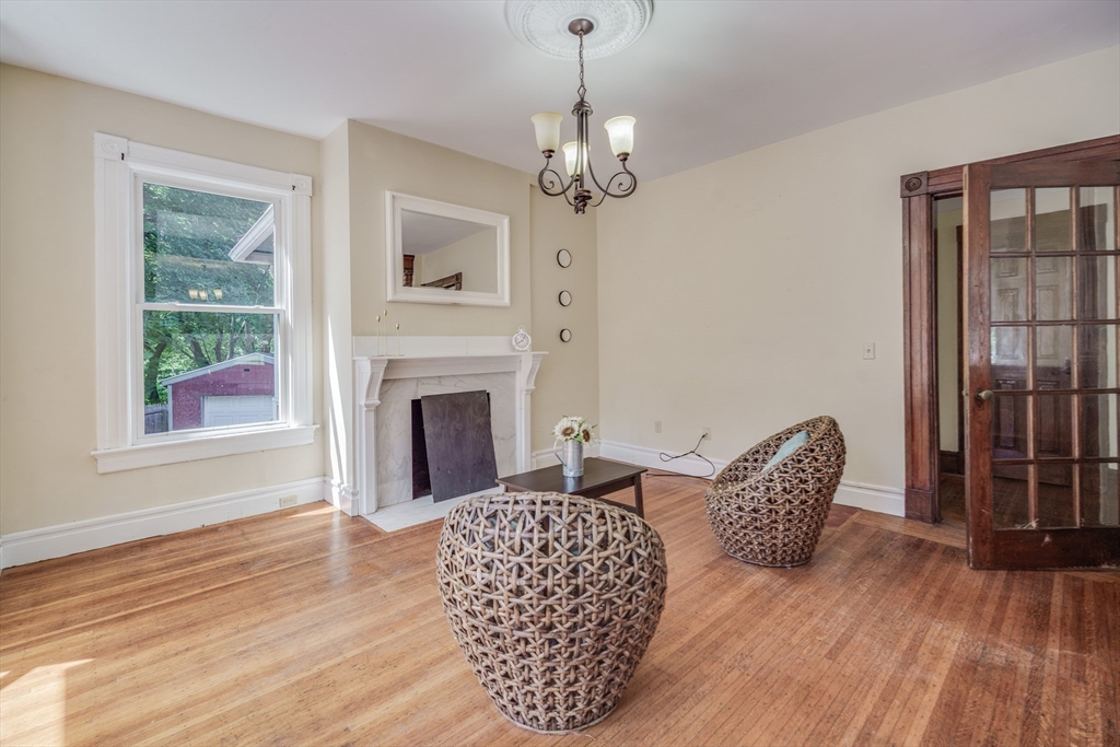 92 Mill Street Springfield, MA 01108 - Photo 10 of 35 a living room with furniture a chandelier and a fireplace