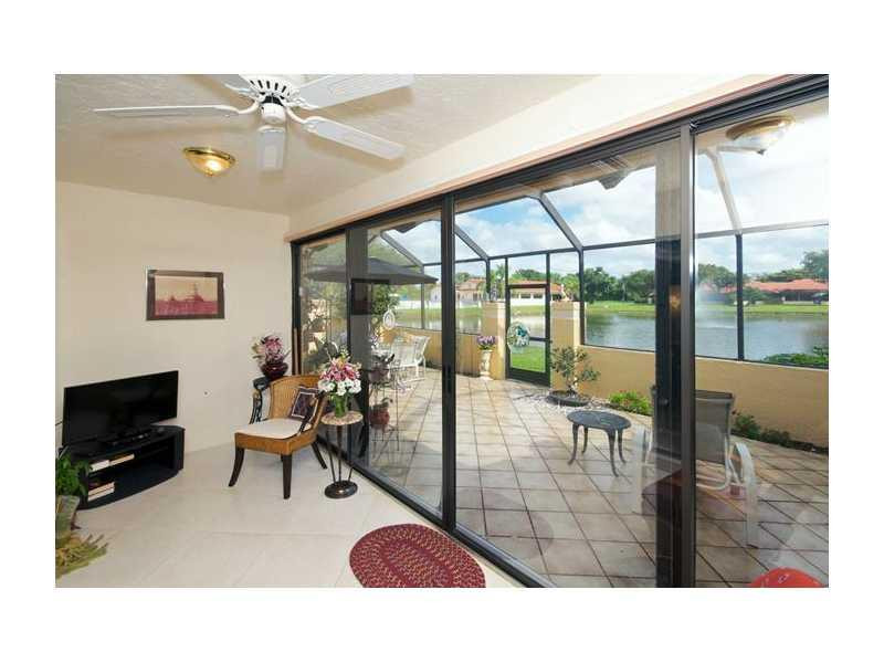 19972 Mona Circle, Unit 19972 Boca Raton, FL 33434 - Photo 11 of 22 a living room with furniture and a flat screen tv