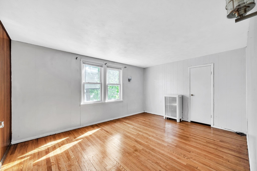 68 Parkside Street Springfield, MA 01104 - Photo 5 of 41 a view of empty room with wooden floor and fan