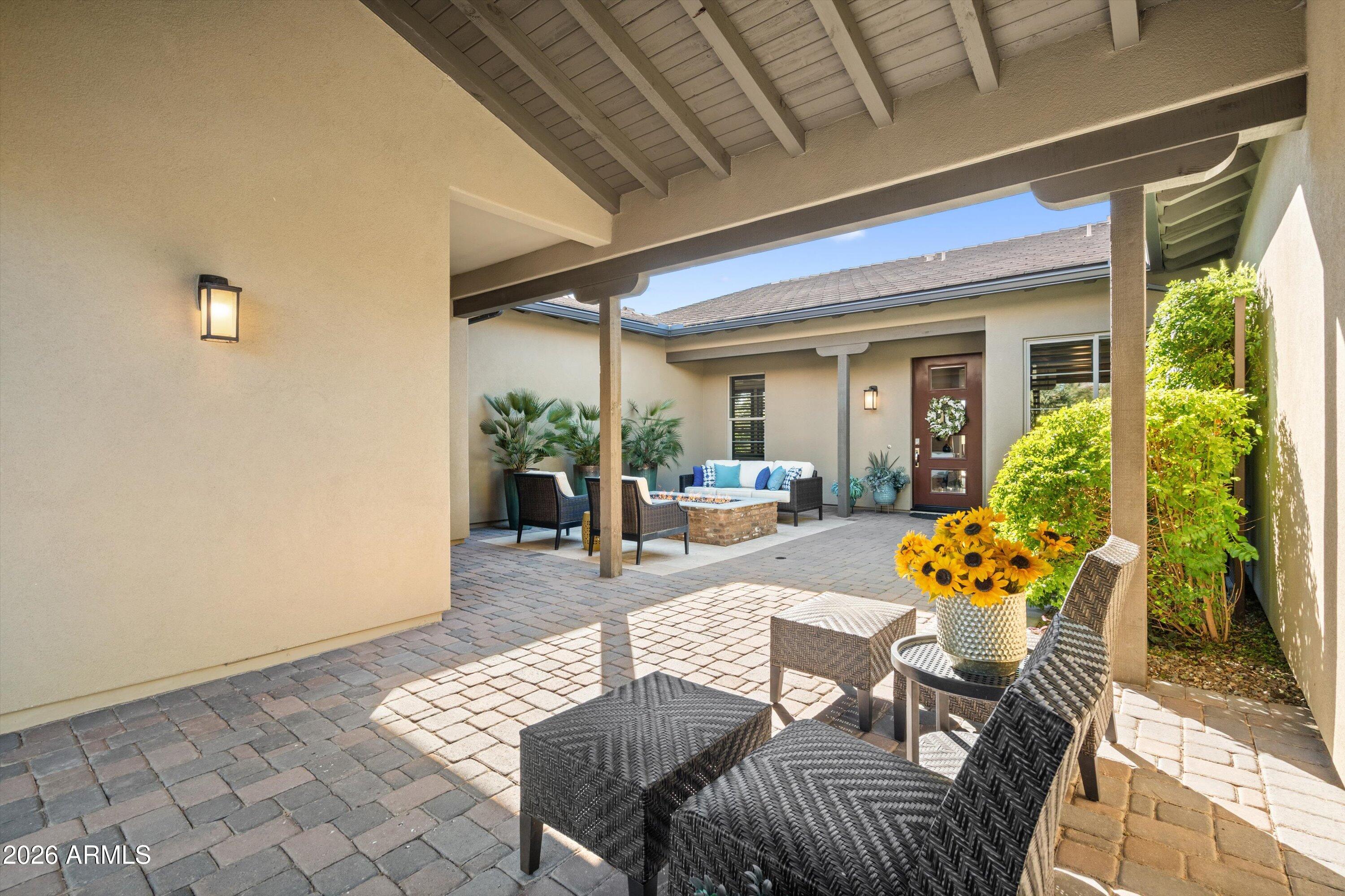17907 East Slide Rock Drive Rio Verde, AZ 85263 - Photo 10 of 82 a view of a patio with couches table and chairs and potted plants