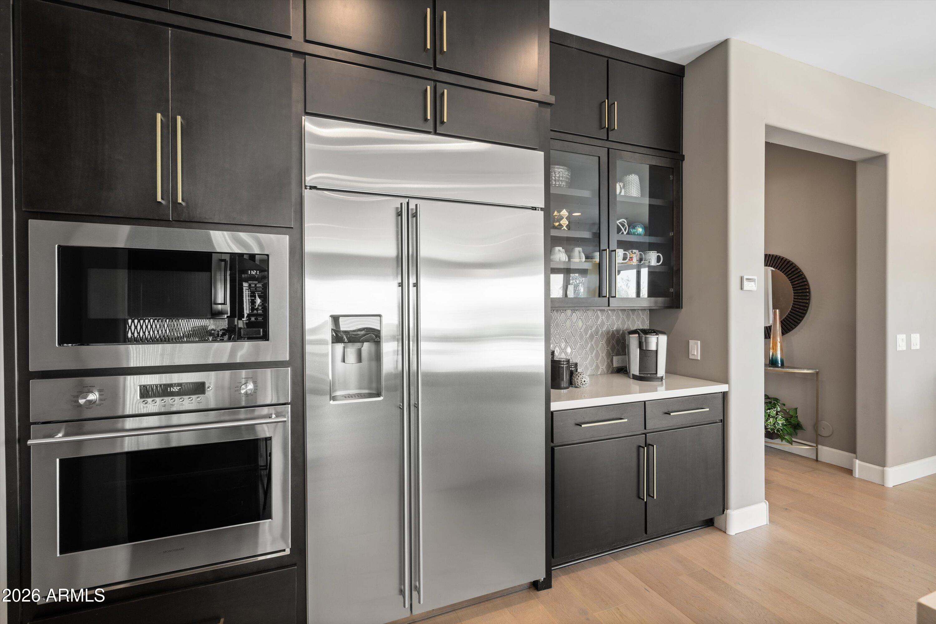 17907 East Slide Rock Drive Rio Verde, AZ 85263 - Photo 20 of 82 a kitchen with stainless steel appliances kitchen island a refrigerator and a stove top oven