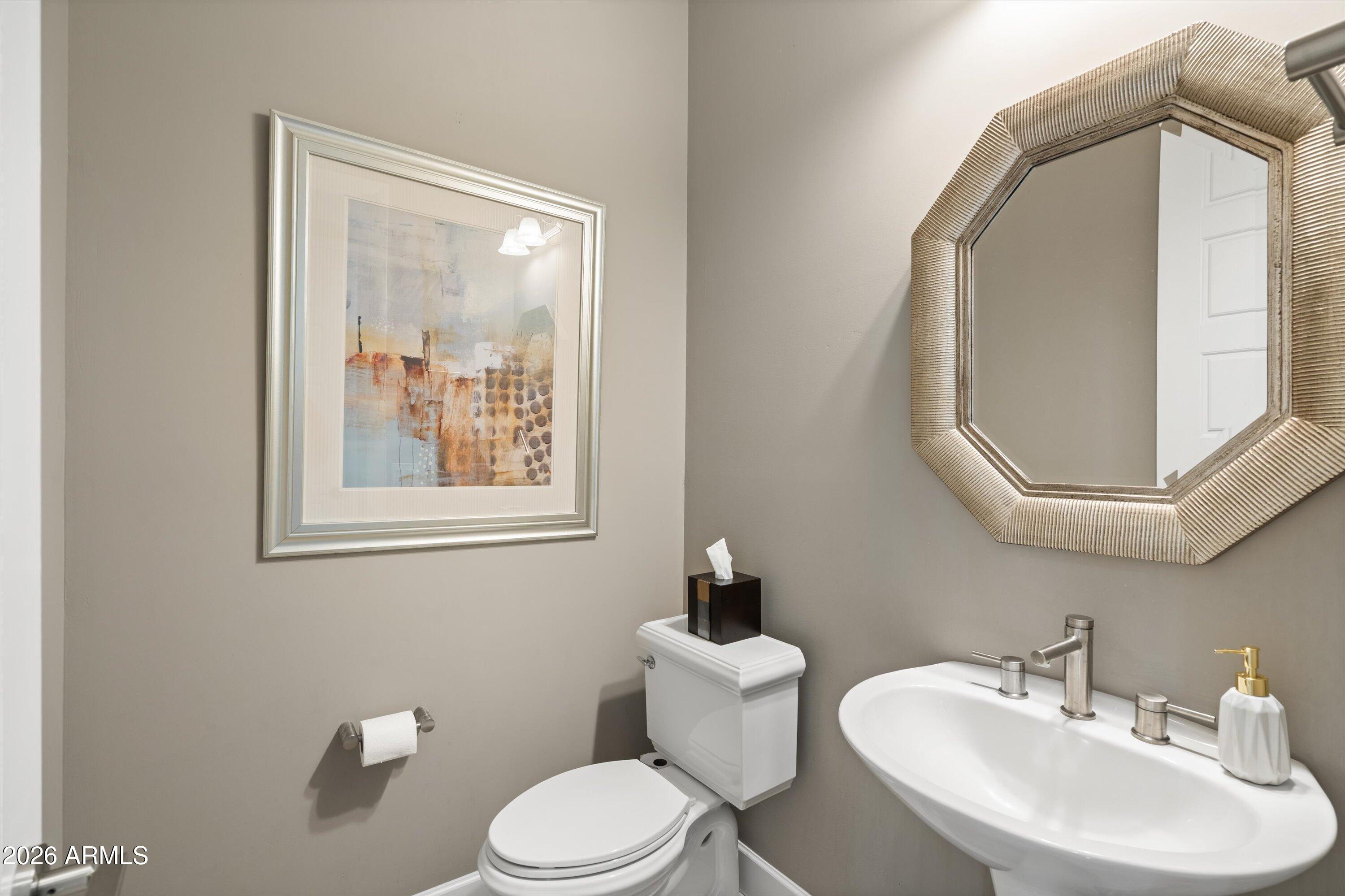 17907 East Slide Rock Drive Rio Verde, AZ 85263 - Photo 54 of 82 a bathroom with a toilet a sink and mirror