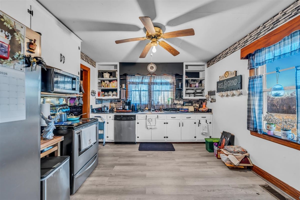 3133 Academy Road Portland, TN 37148 - Photo 9 of 24 a kitchen with stainless steel appliances kitchen island granite countertop a stove and a white cabinets