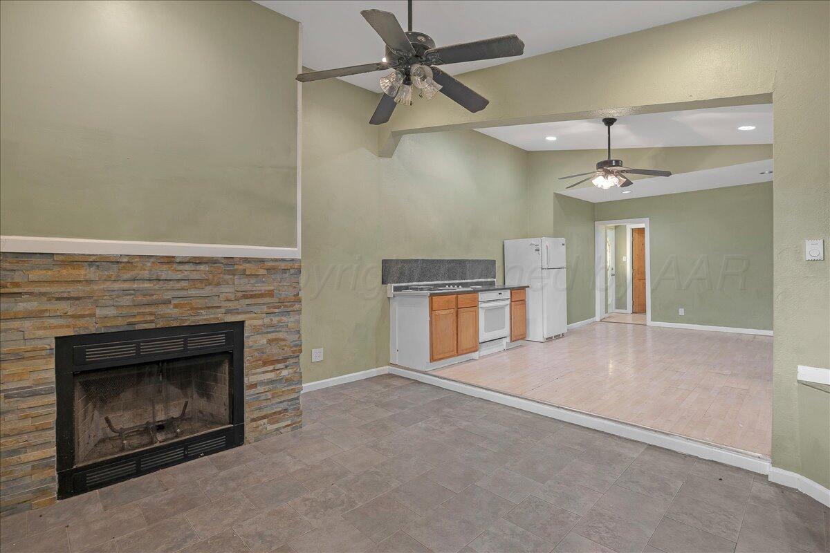 1403 South Hughes Street Amarillo, TX 79102 - Photo 13 of 54 an empty room with windows and fireplace