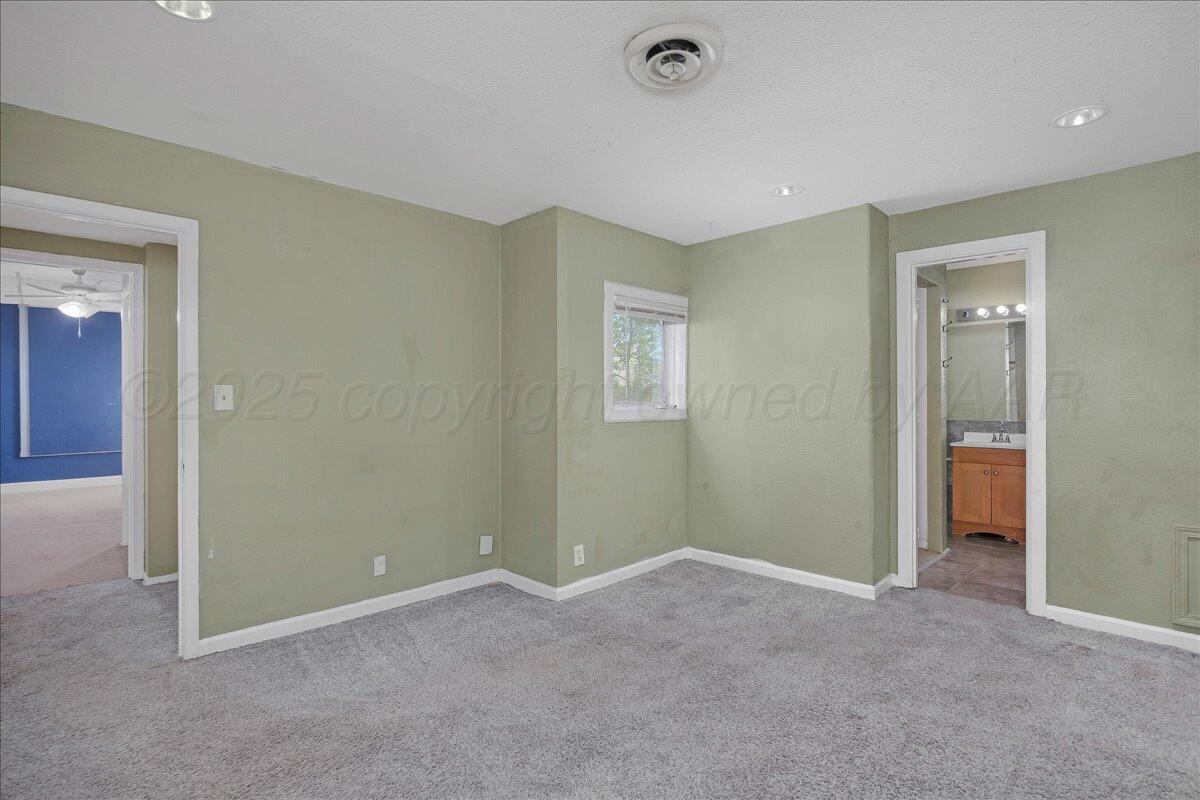 1403 South Hughes Street Amarillo, TX 79102 - Photo 19 of 54 an empty room with windows and closet