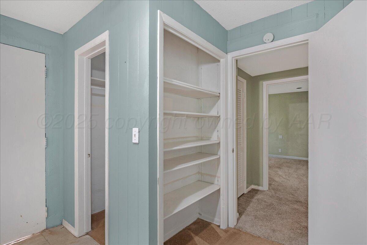 1403 South Hughes Street Amarillo, TX 79102 - Photo 23 of 54 a view of a hallway with closet