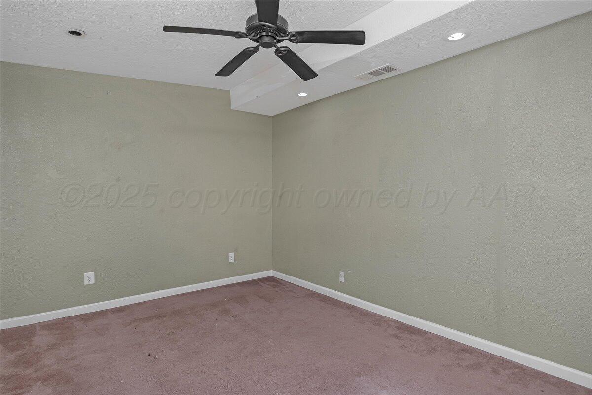 1403 South Hughes Street Amarillo, TX 79102 - Photo 24 of 54 an empty room with a window and a fan