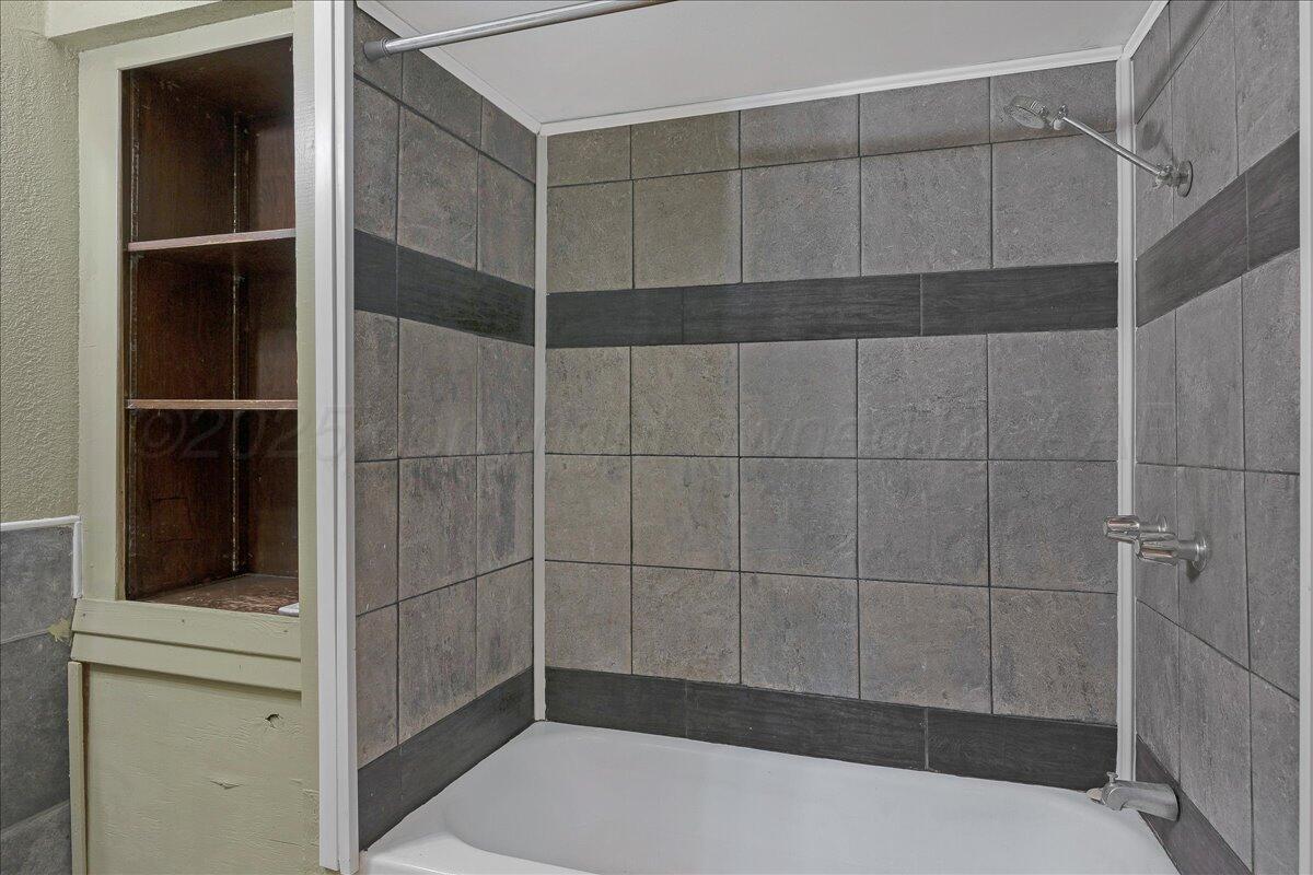 1403 South Hughes Street Amarillo, TX 79102 - Photo 26 of 54 a bathroom with a shower and a sink