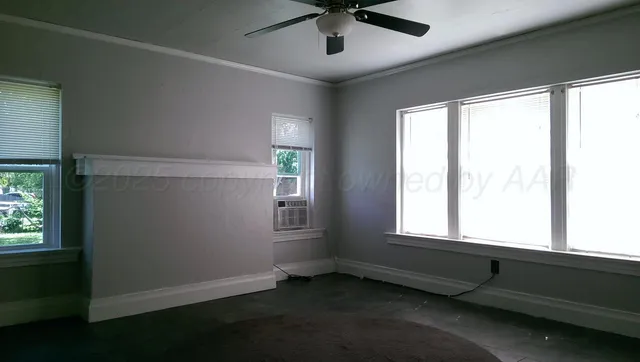 a view of an empty room with a window
