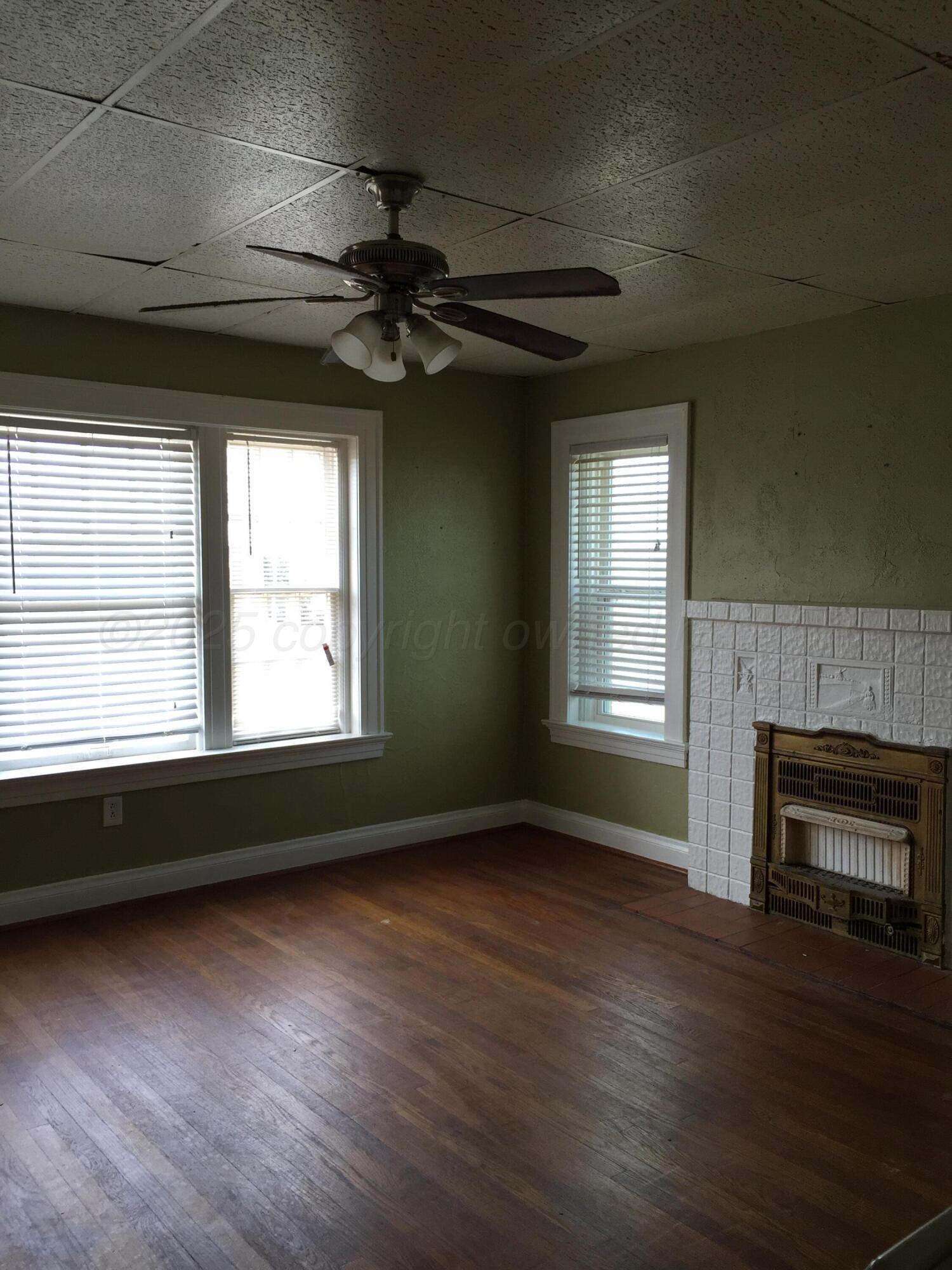 1403 South Hughes Street Amarillo, TX 79102 - Photo 33 of 54 a view of an empty room with wooden floor and a window