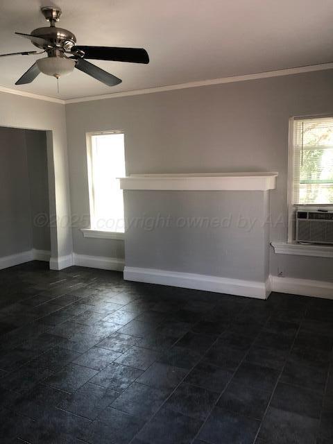 1403 South Hughes Street Amarillo, TX 79102 - Photo 35 of 54 an empty room with wooden floor fan and windows