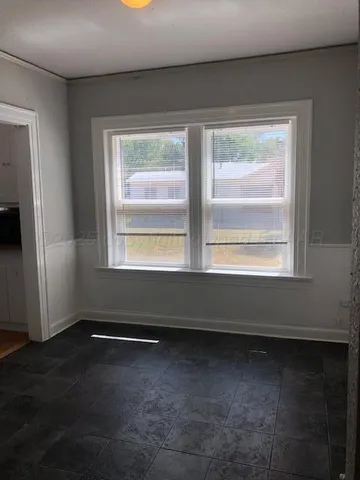 a view of room with window and hardwood floor