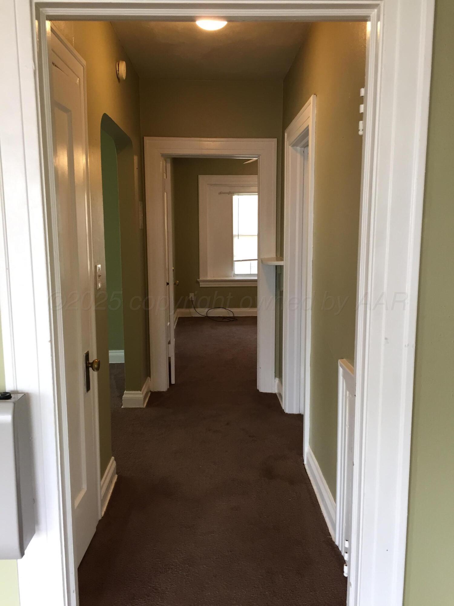 1403 South Hughes Street Amarillo, TX 79102 - Photo 41 of 54 a view of a hallway with wooden floor