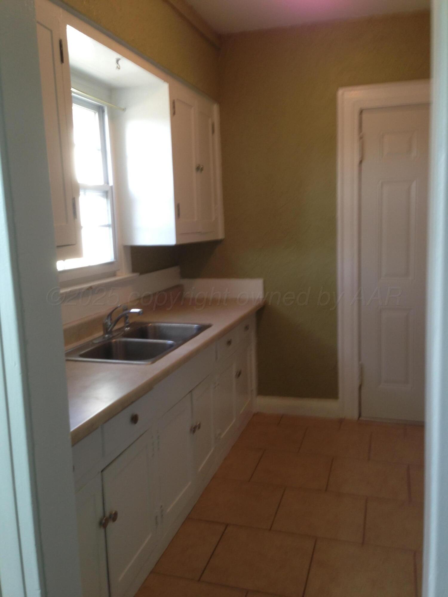 1403 South Hughes Street Amarillo, TX 79102 - Photo 45 of 54 a bathroom with a sink and a window