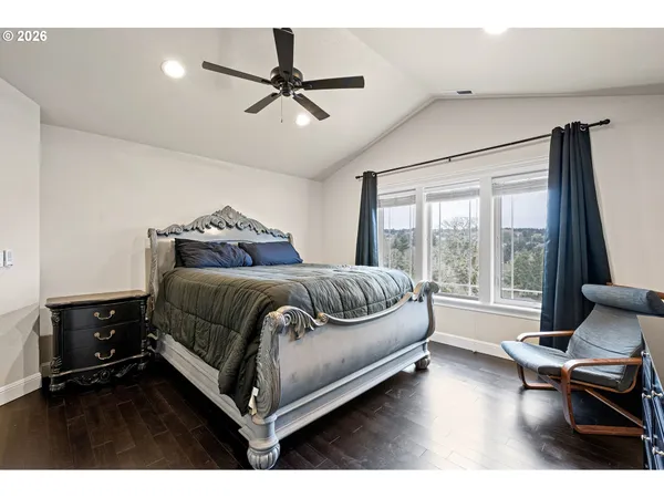 a living room with a bed furniture and a large window