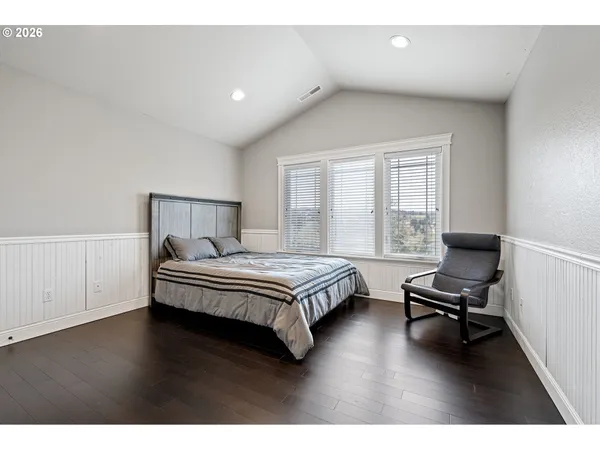 a bedroom with a bed and a chair