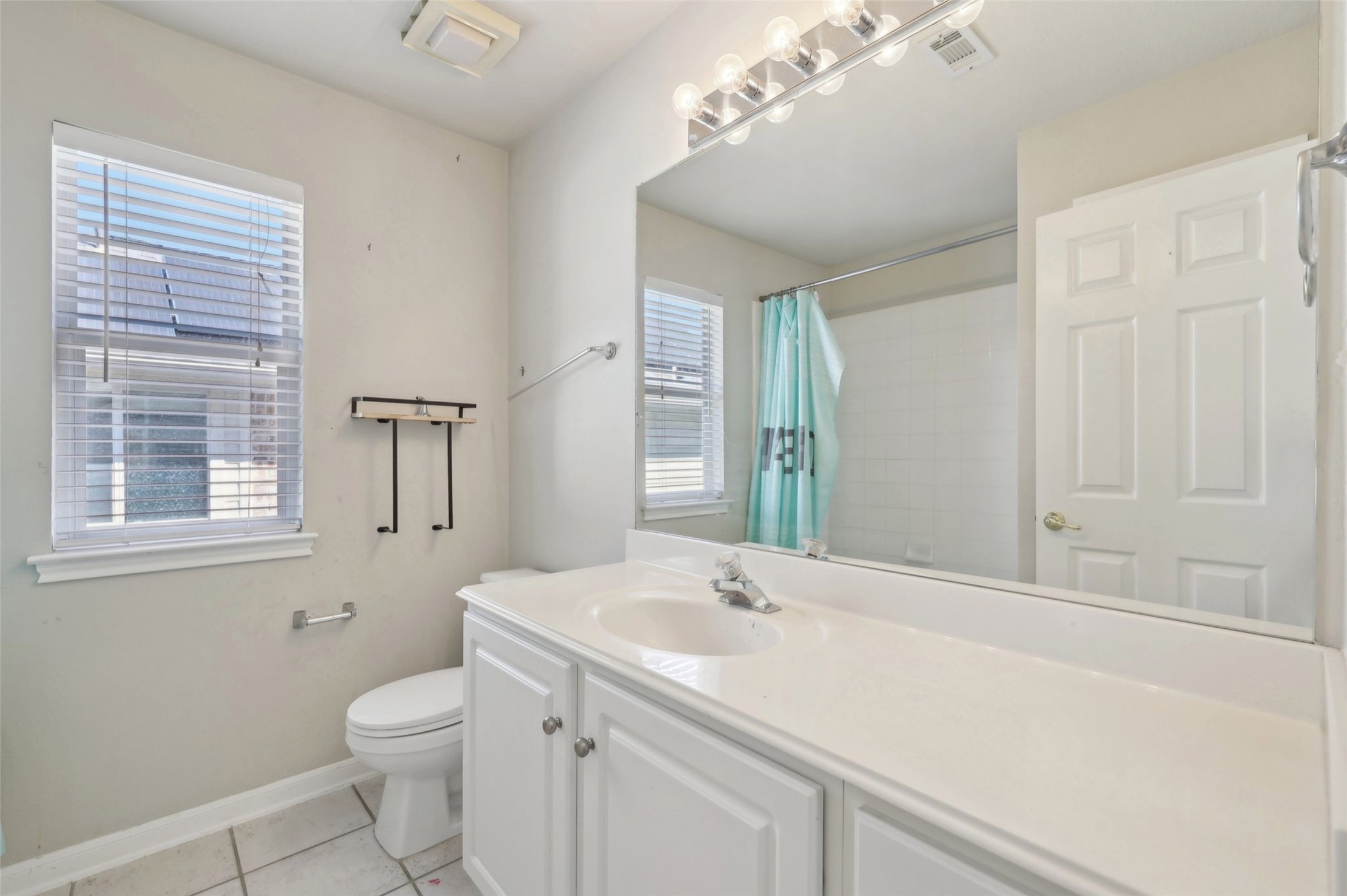 2948 Grimes Ranch Road Austin, TX 78732 - Photo 17 of 40 Full bath with plenty of natural light, tile patterned floors, toilet, and vanity