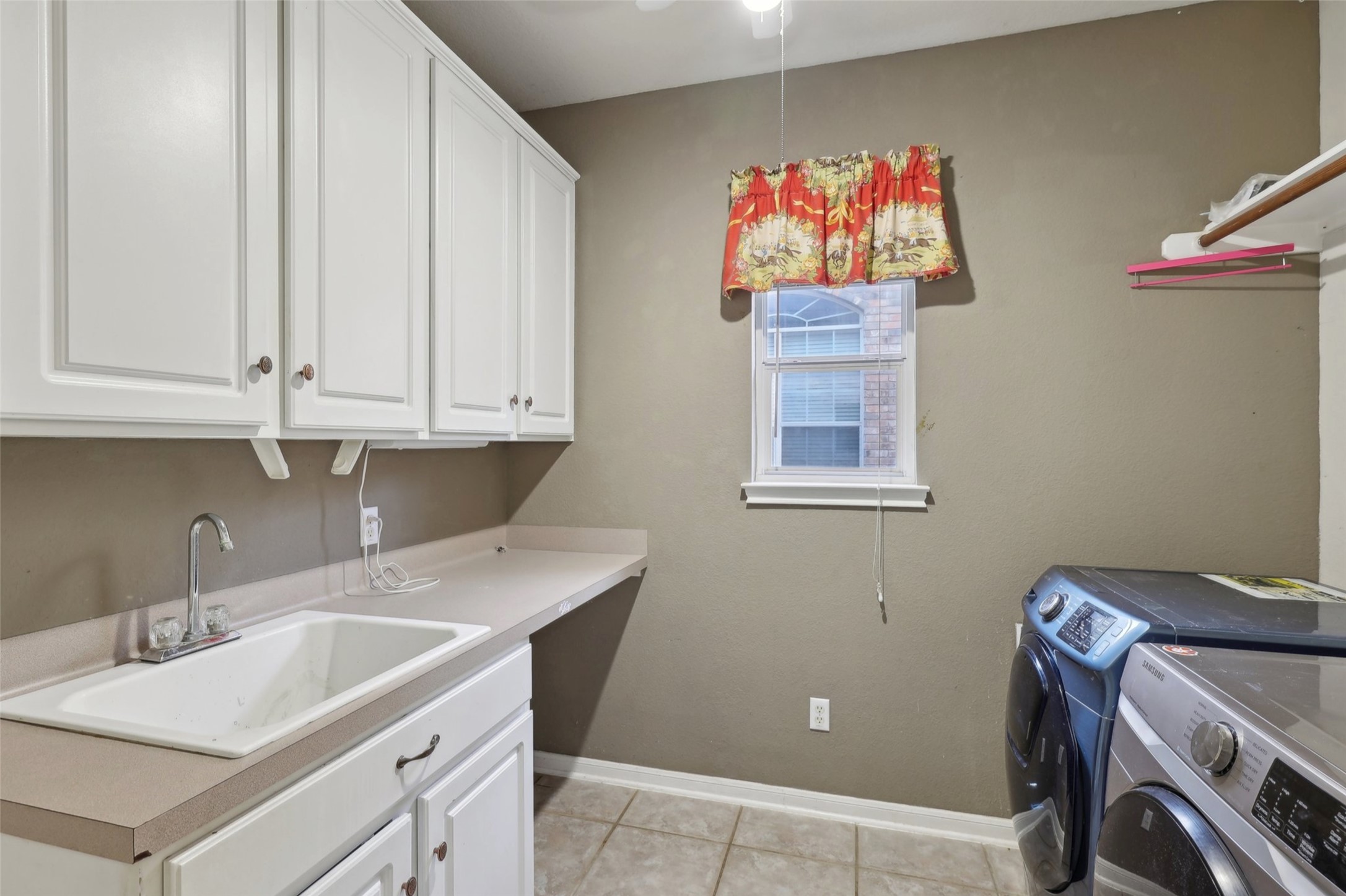 2948 Grimes Ranch Road Austin, TX 78732 - Photo 19 of 40 Laundry area featuring a sink , storage cabinets and Washer/Dryer.