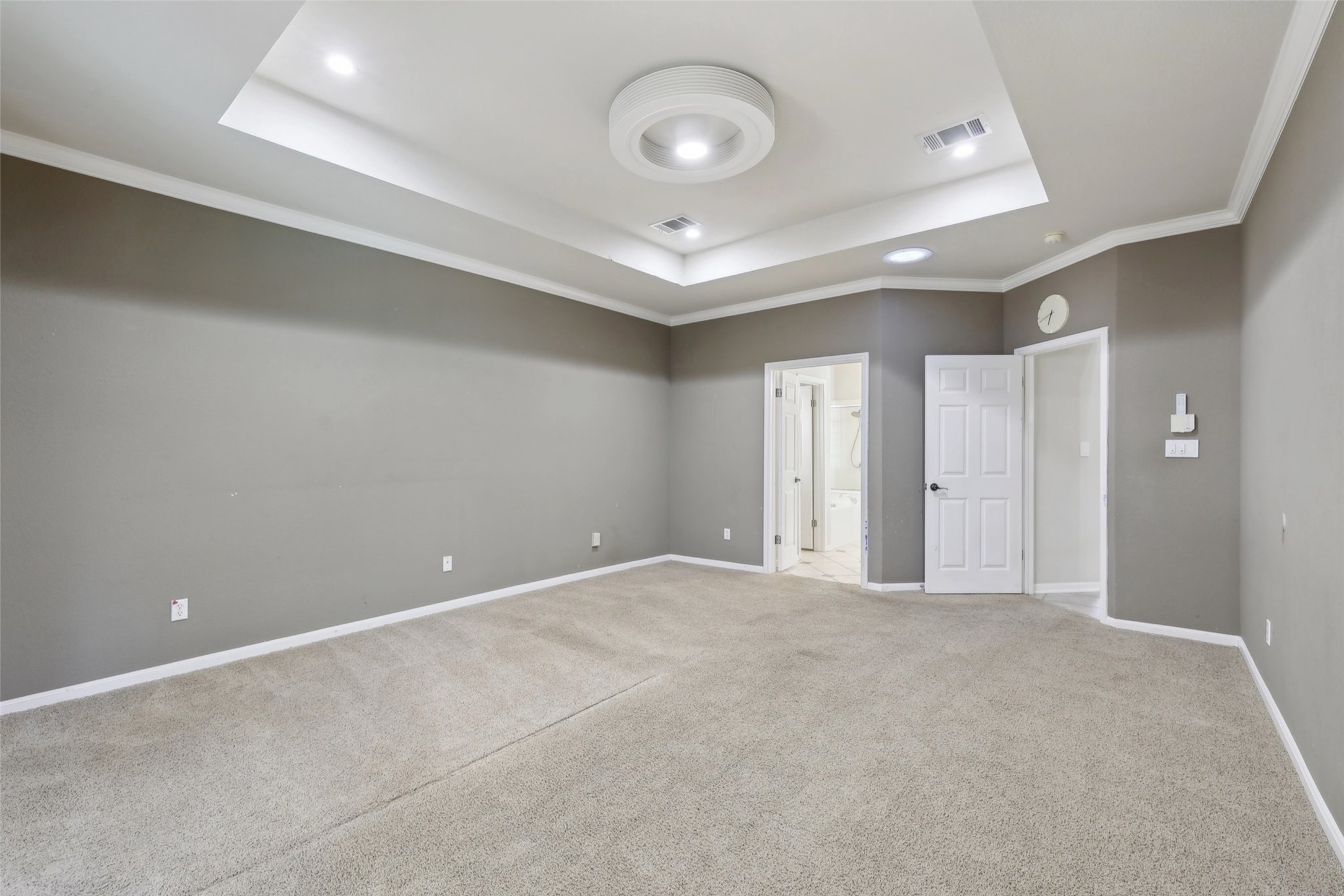 2948 Grimes Ranch Road Austin, TX 78732 - Photo 21 of 40 Carpeted empty room with a raised ceiling, crown molding, baseboards, and recessed lighting.