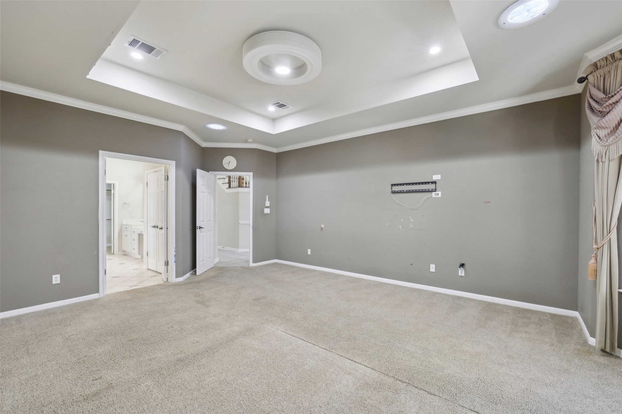 2948 Grimes Ranch Road Austin, TX 78732 - Photo 22 of 40 Carpeted empty room with a raised ceiling, crown molding, baseboards, and recessed lighting.