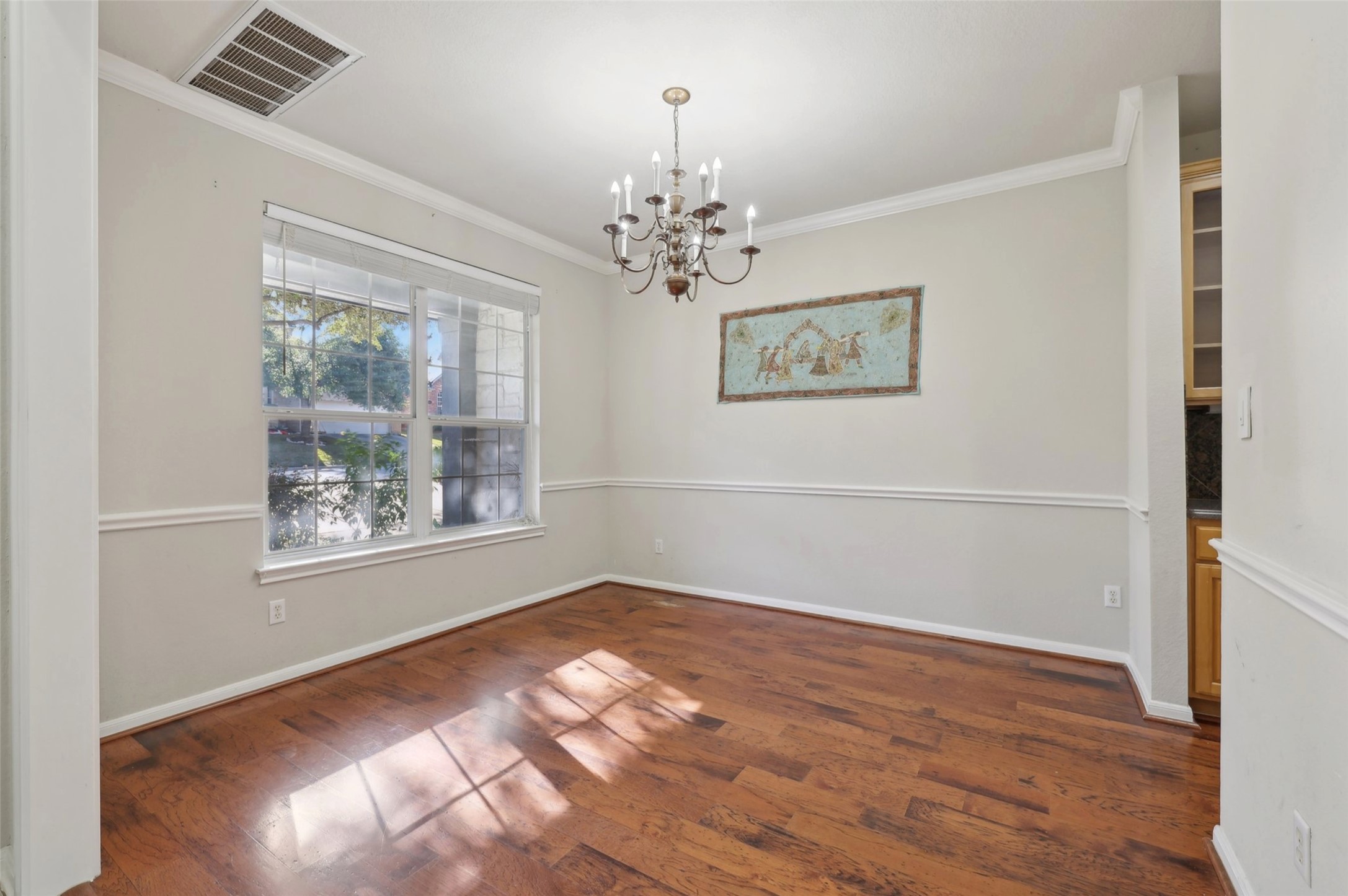 2948 Grimes Ranch Road Austin, TX 78732 - Photo 4 of 40 Unfurnished dining area featuring a chandelier, ornamental molding, wood finished floors, baseboards, and recessed lighting