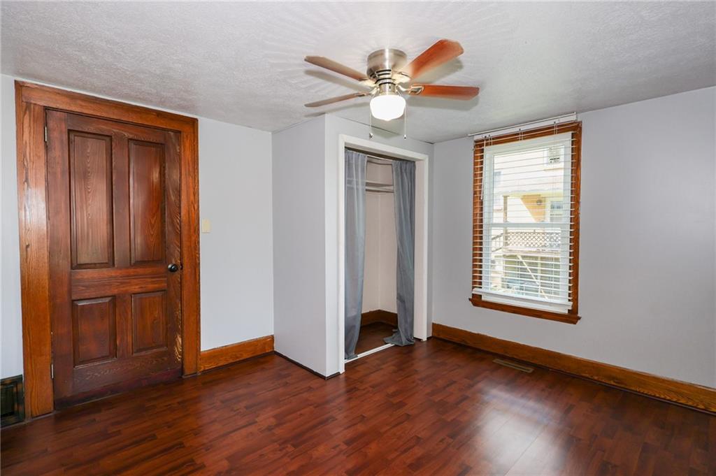 311 Center Street Slippery Rock, PA 16057 - Photo 14 of 32 an empty room with wooden floor closet and windows