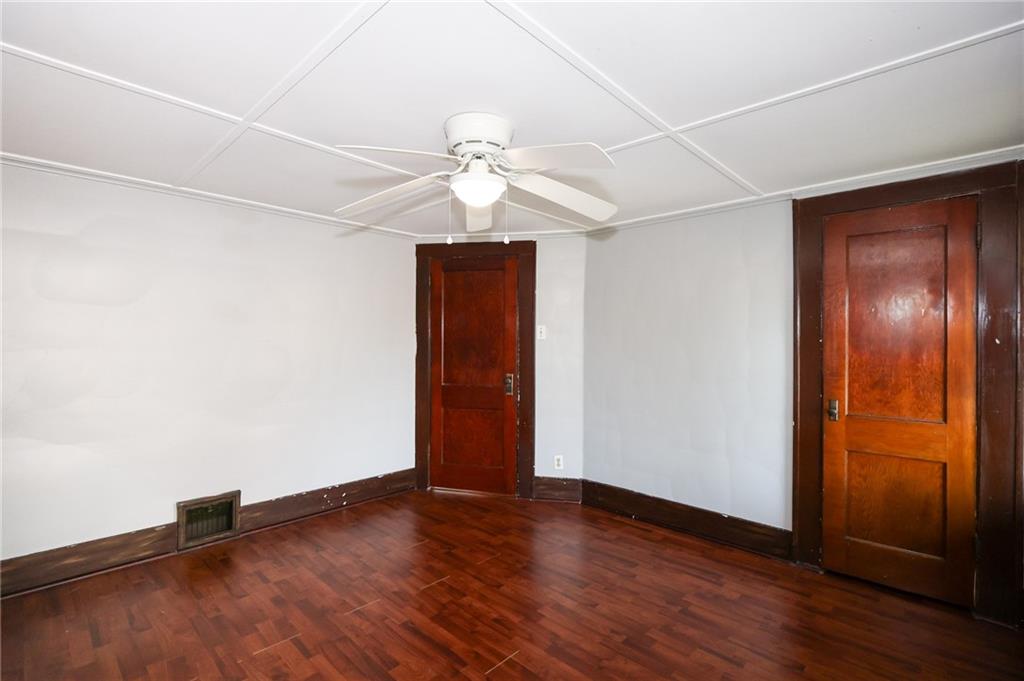311 Center Street Slippery Rock, PA 16057 - Photo 24 of 32 an empty room with wooden floor and fan