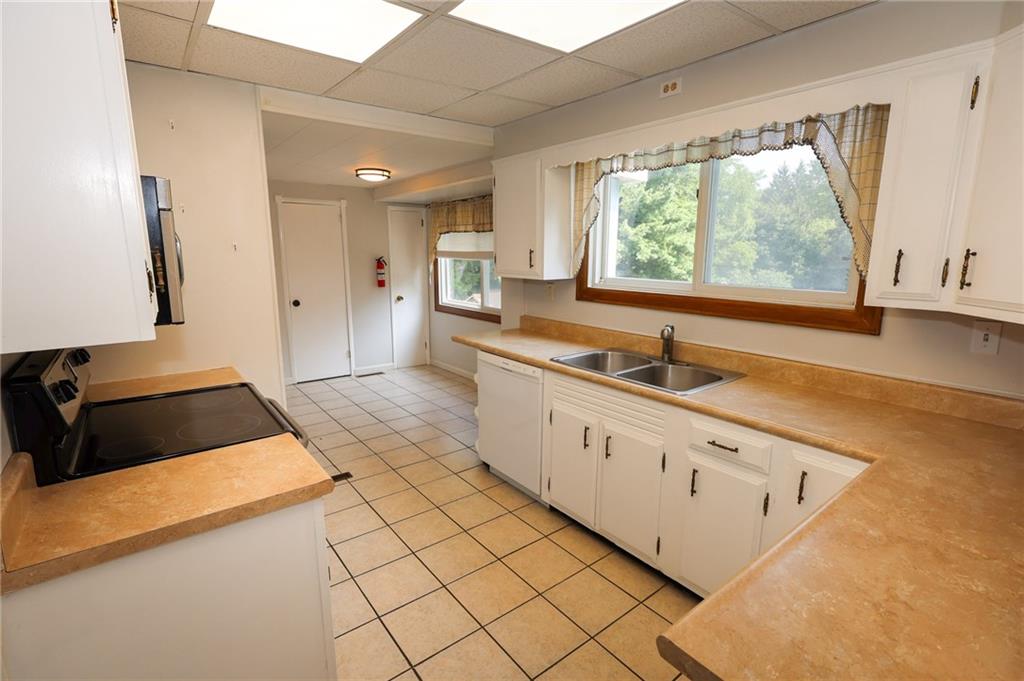 311 Center Street Slippery Rock, PA 16057 - Photo 8 of 32 a kitchen with granite countertop white cabinets and a window