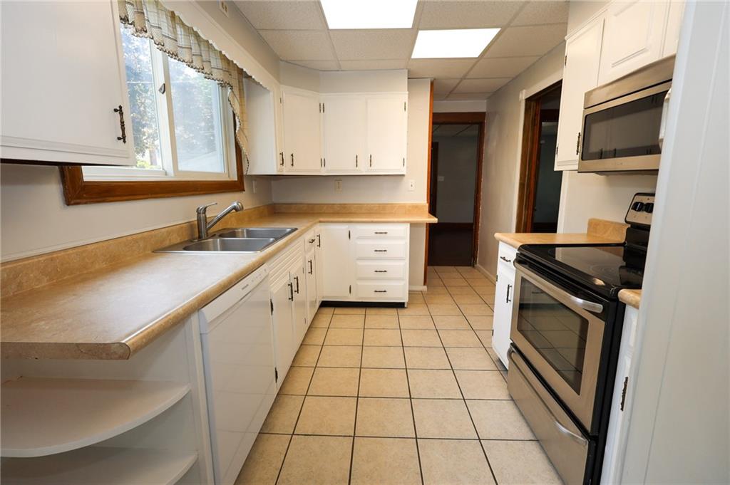 311 Center Street Slippery Rock, PA 16057 - Photo 9 of 32 a kitchen with a sink stove and cabinets