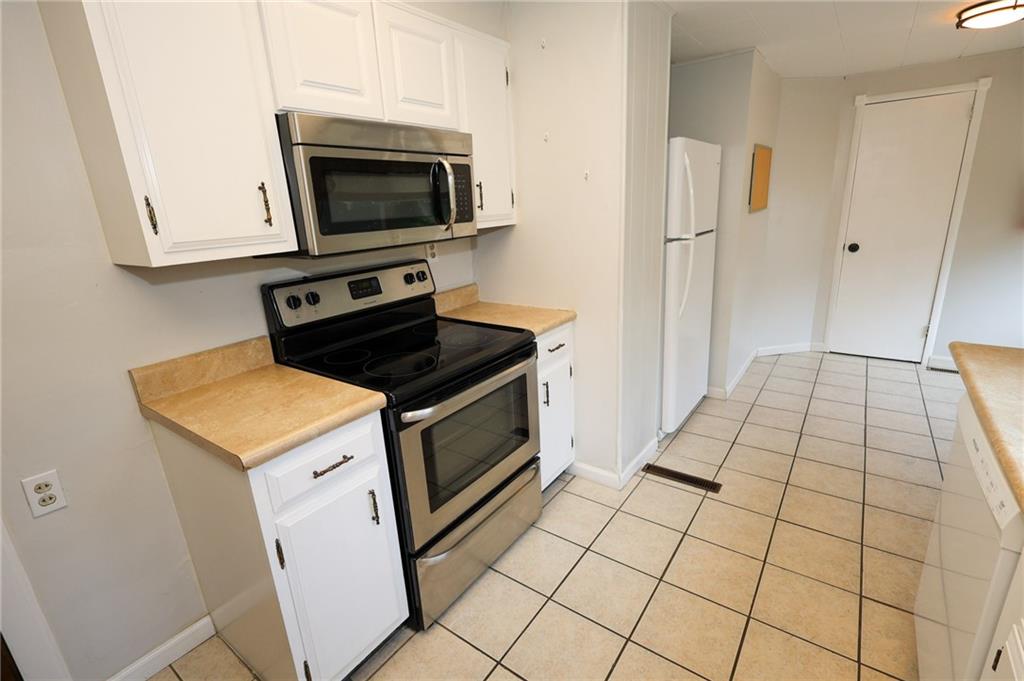 311 Center Street Slippery Rock, PA 16057 - Photo 10 of 32 a kitchen with a stove and a microwave